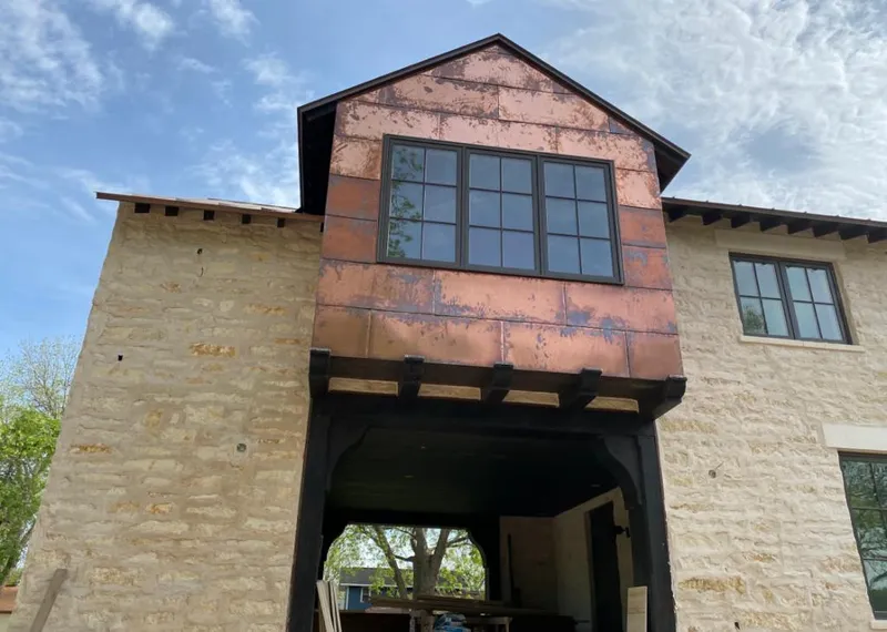 Copper metal panel facade on a stone building for Skylight Installation in Gibsonton